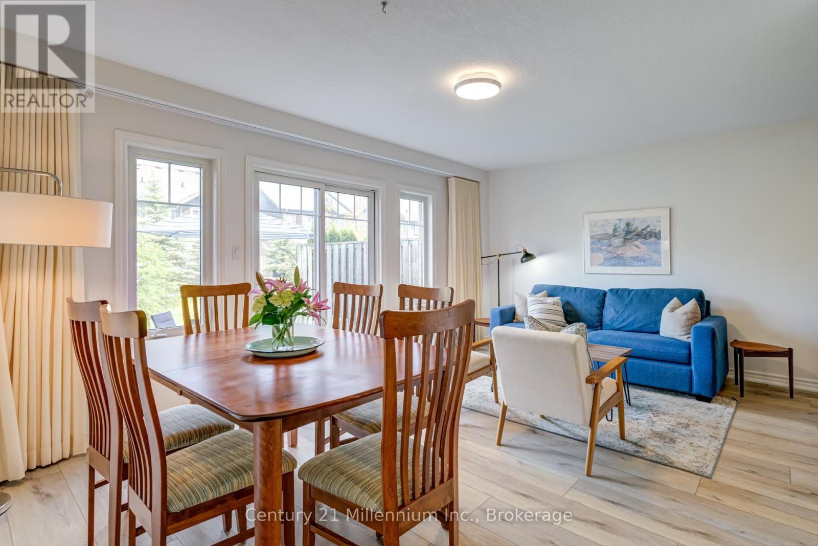 A dining room with a wooden table and chairs.