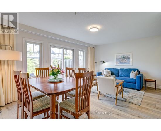 A dining room with a wooden table and chairs.