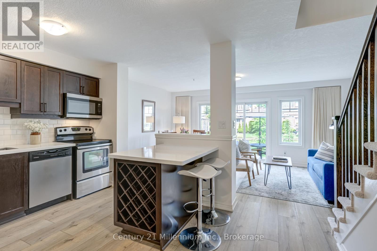 A kitchen with wooden cabinets and a white island.