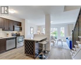 A kitchen with wooden cabinets and a white island.