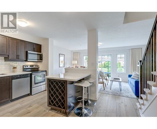 A kitchen with wooden cabinets and a white island.