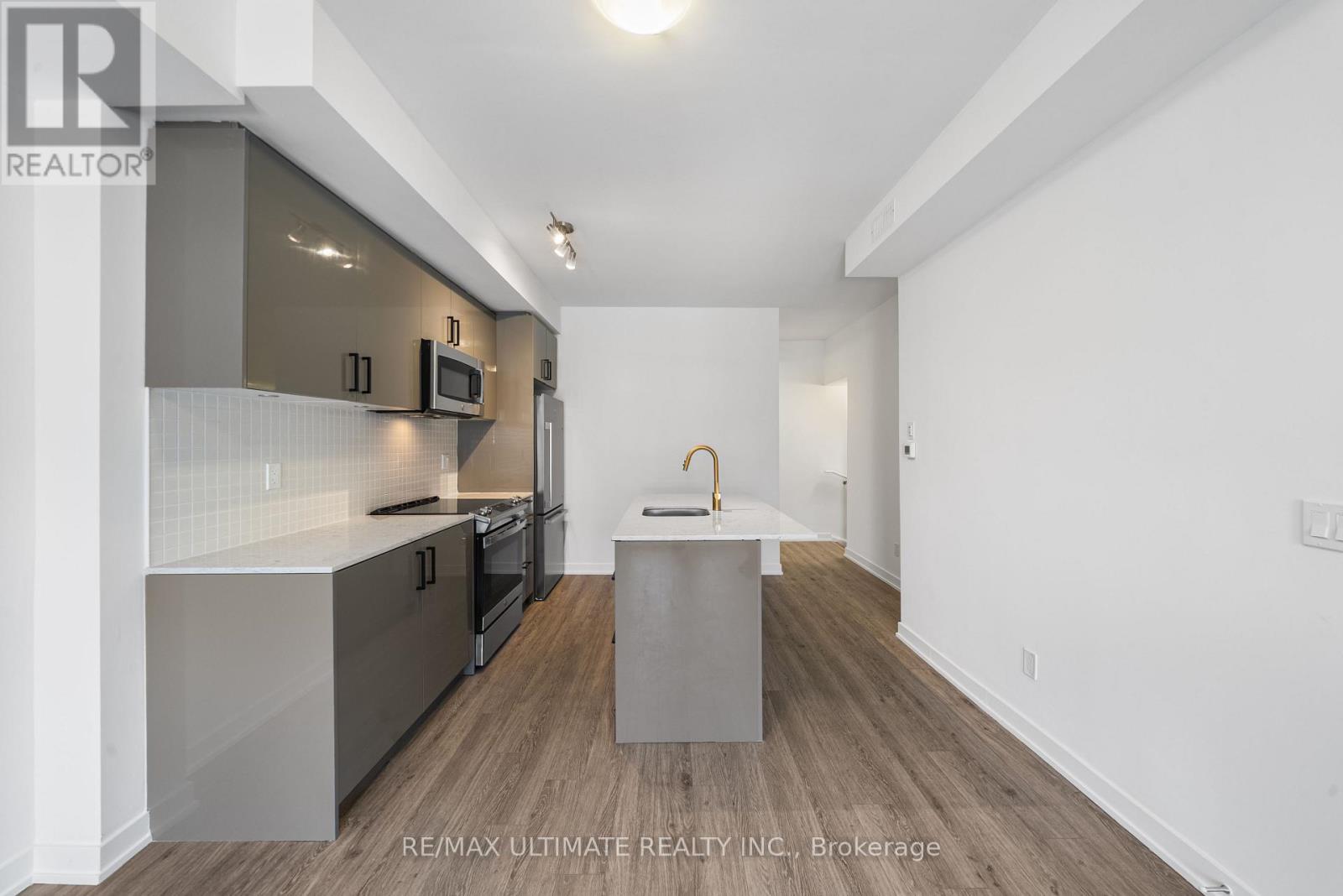A modern kitchen with a white and grey color scheme.