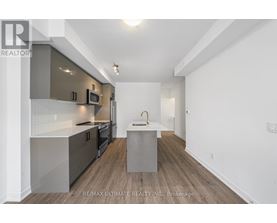 A modern kitchen with a white and grey color scheme.