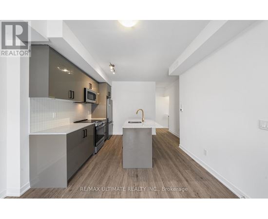 A modern kitchen with a white and grey color scheme.