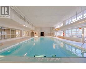 A large indoor swimming pool with the words "Bay Street Group Inc. Brokerage" written on the bottom.