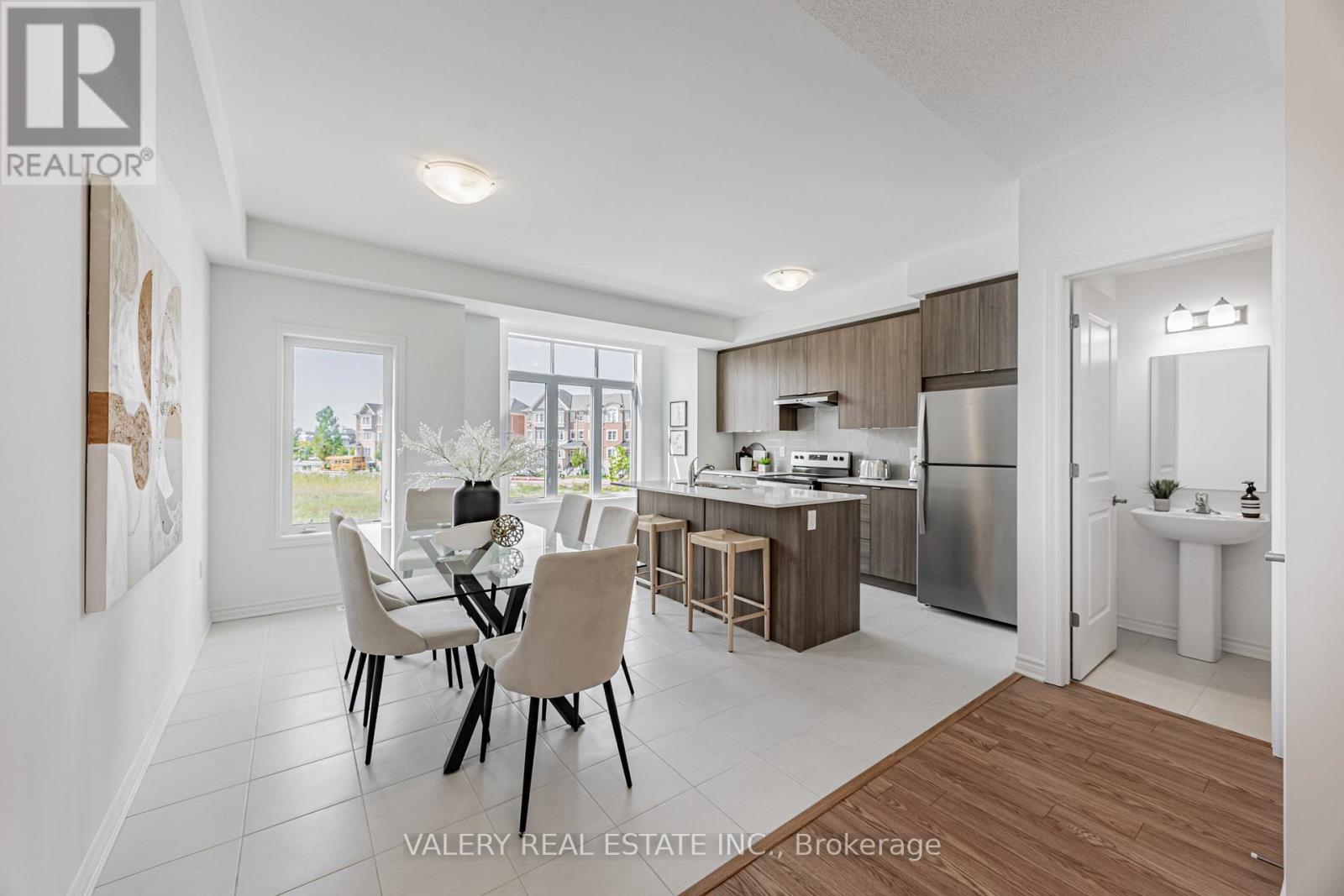 A modern kitchen with a dining table and chairs.