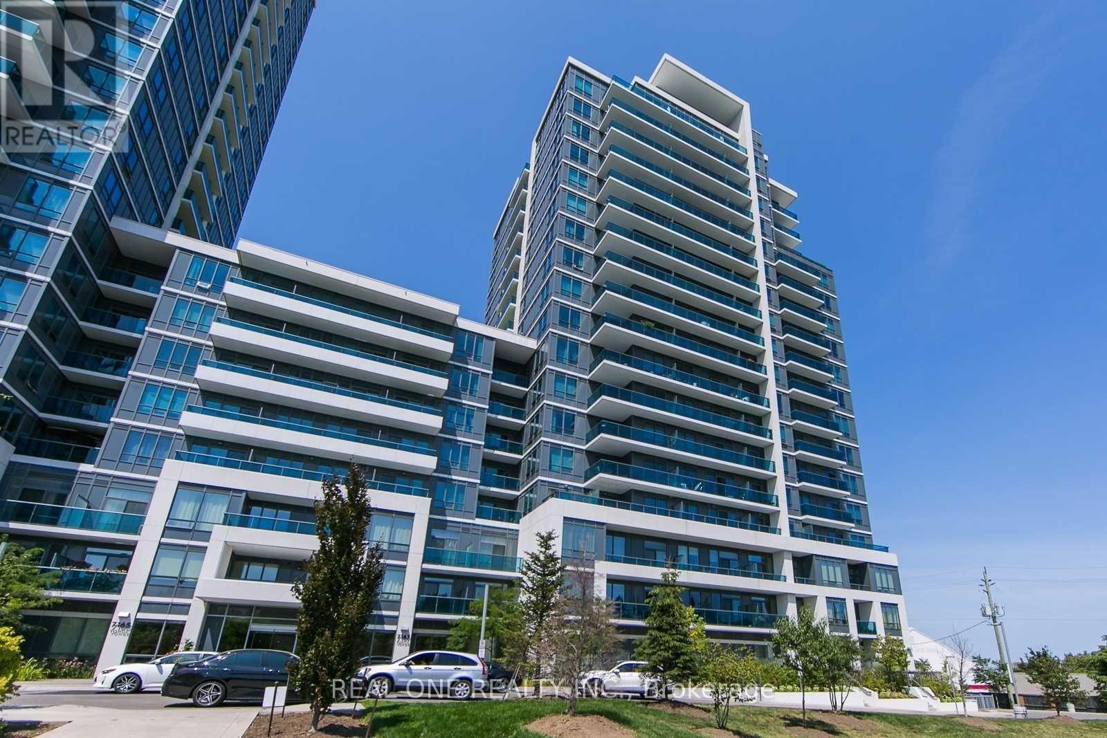 A modern multi-story residential building with a clear blue sky in the background.