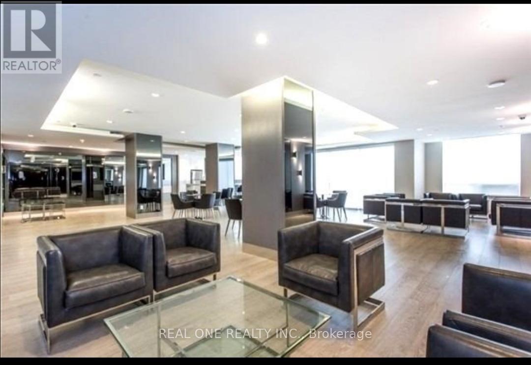 A spacious living room with leather chairs and a glass table.