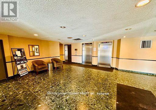 A spacious room with a marble floor and a small table with two chairs.