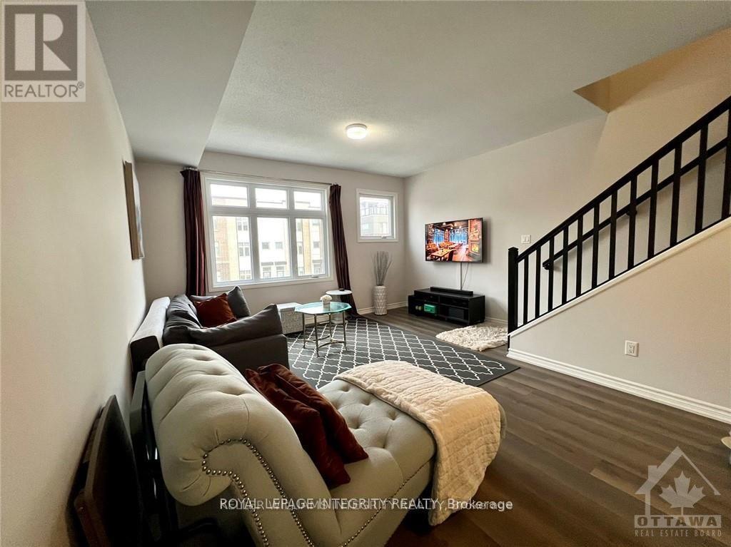 A living room with a couch, a chair, and a coffee table.
