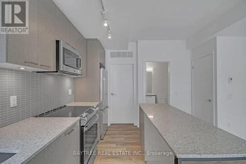 A modern kitchen with a microwave above the stove.