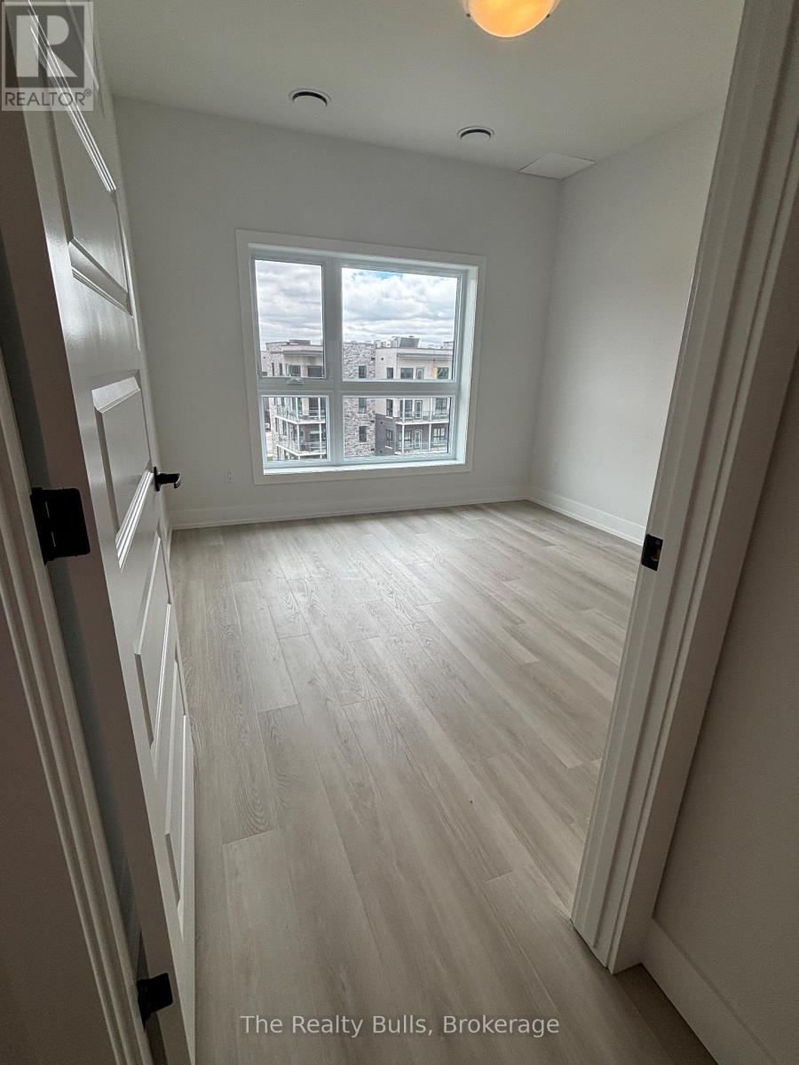 A room with a window overlooking a building with the text "The Realty Bulls, Brokerage" on the bottom.