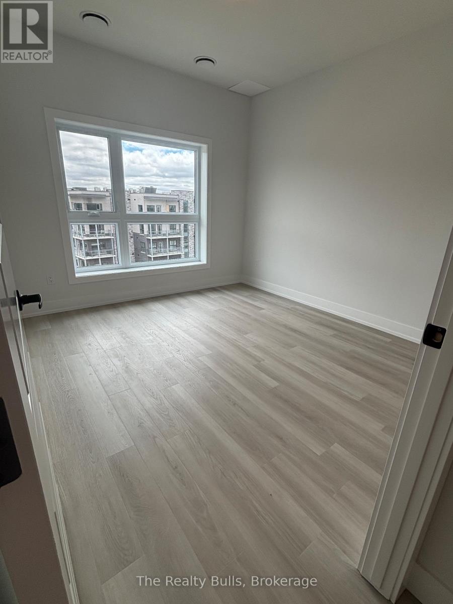 A room with a view of apartment buildings across the street.