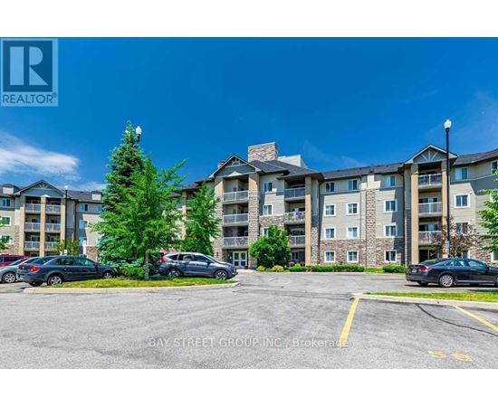 A parking lot in front of a multi-story apartment building.