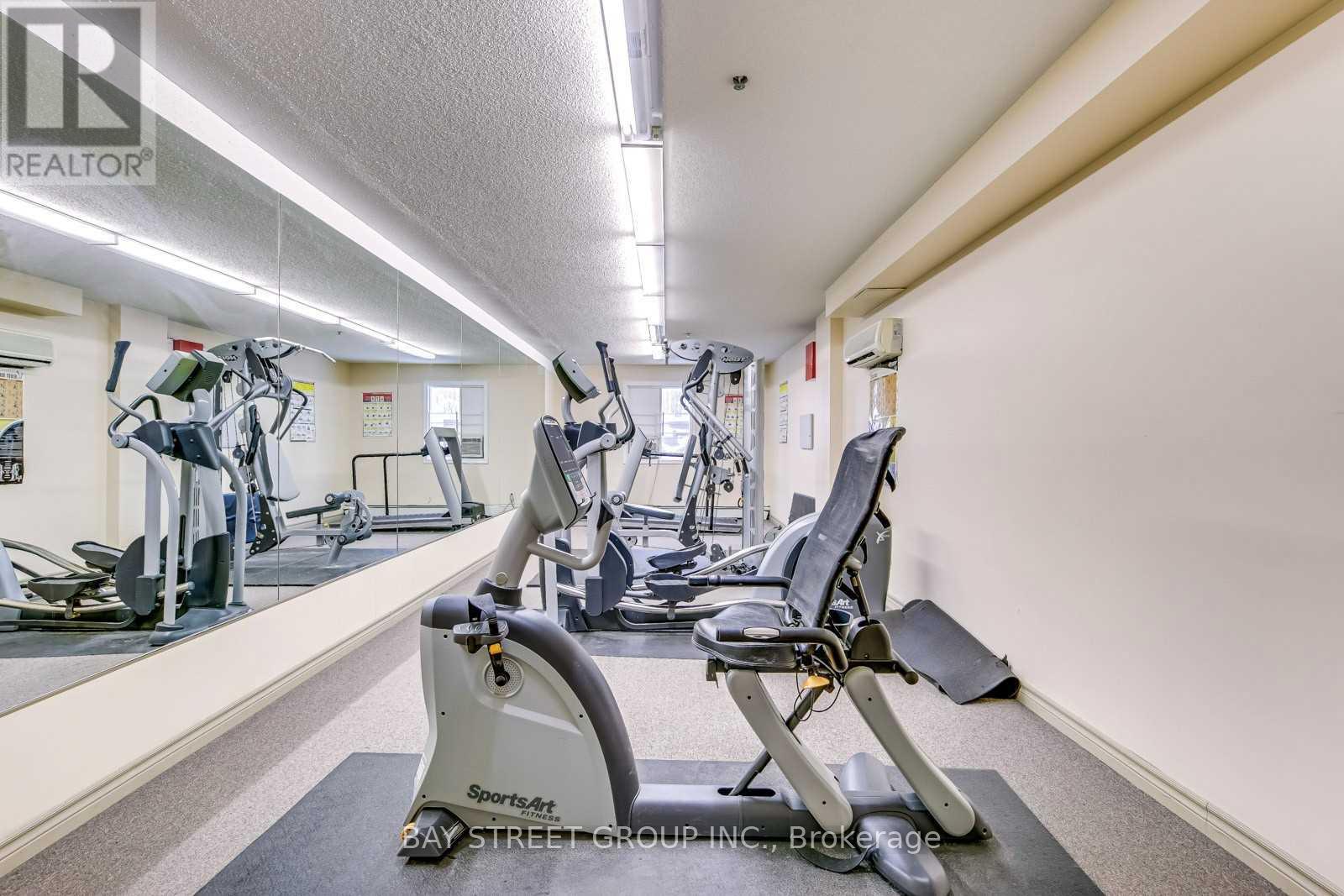 A gym with a row of exercise bikes.