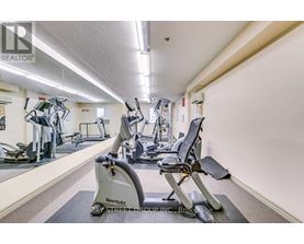 A gym with a row of exercise bikes.