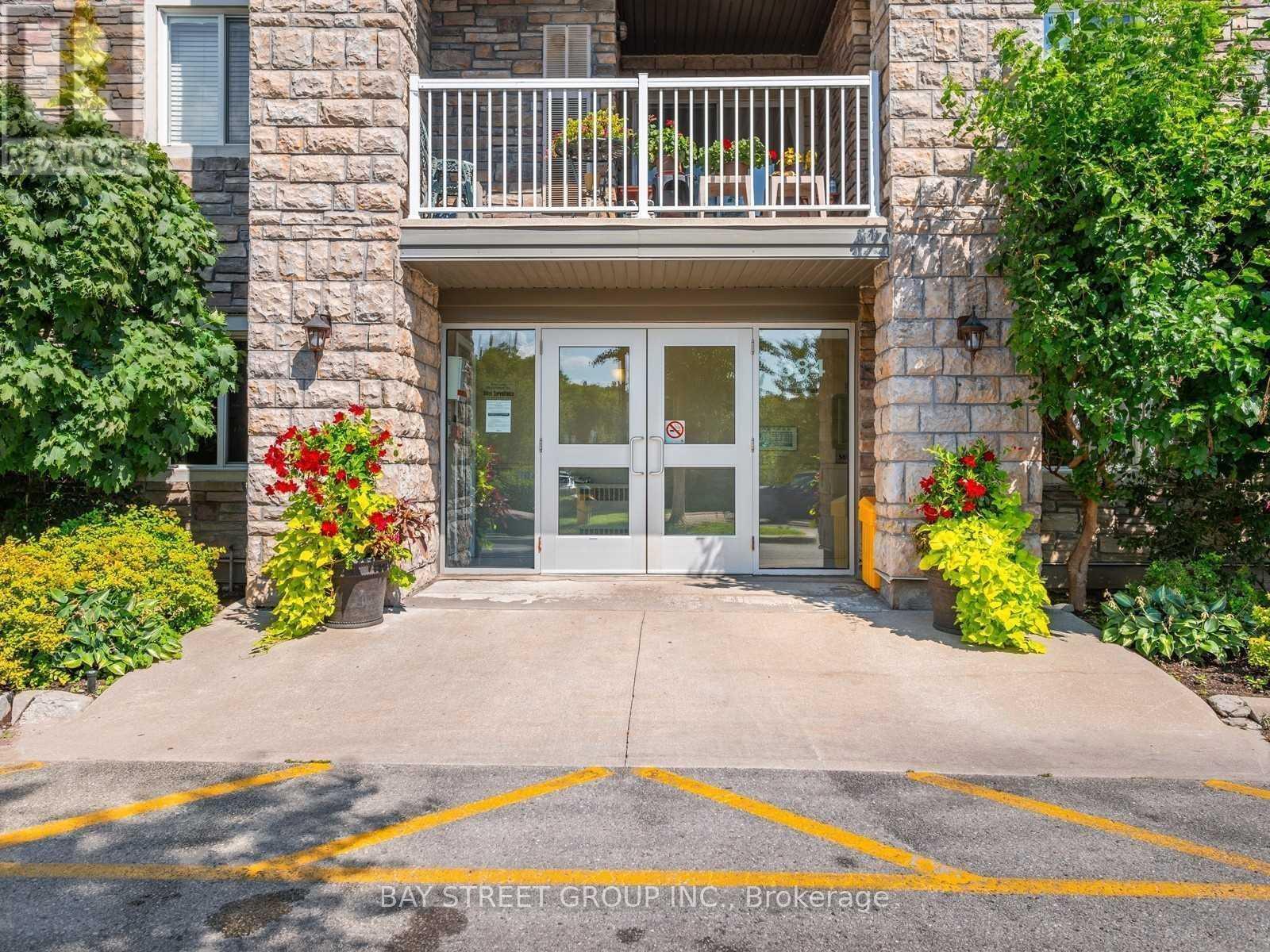 The entrance to a building with a glass door and a balcony.