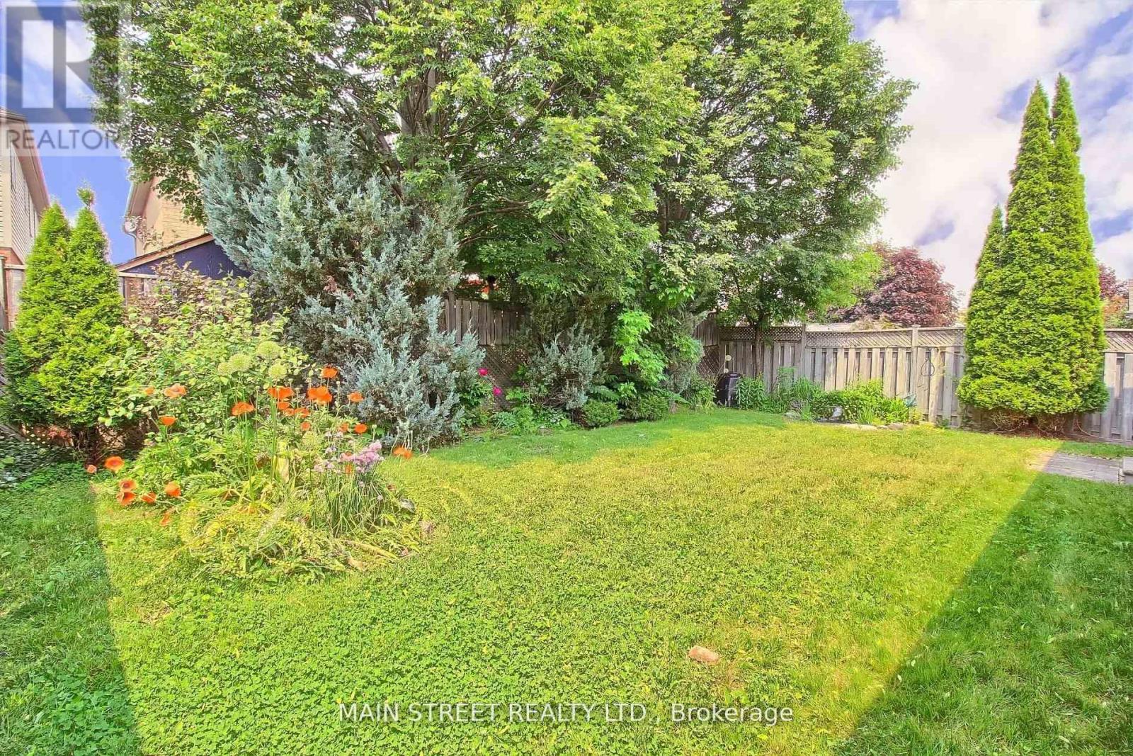 A well-maintained garden with a variety of plants and trees.