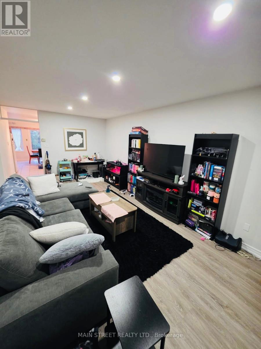 A living room with a grey couch and a black coffee table.