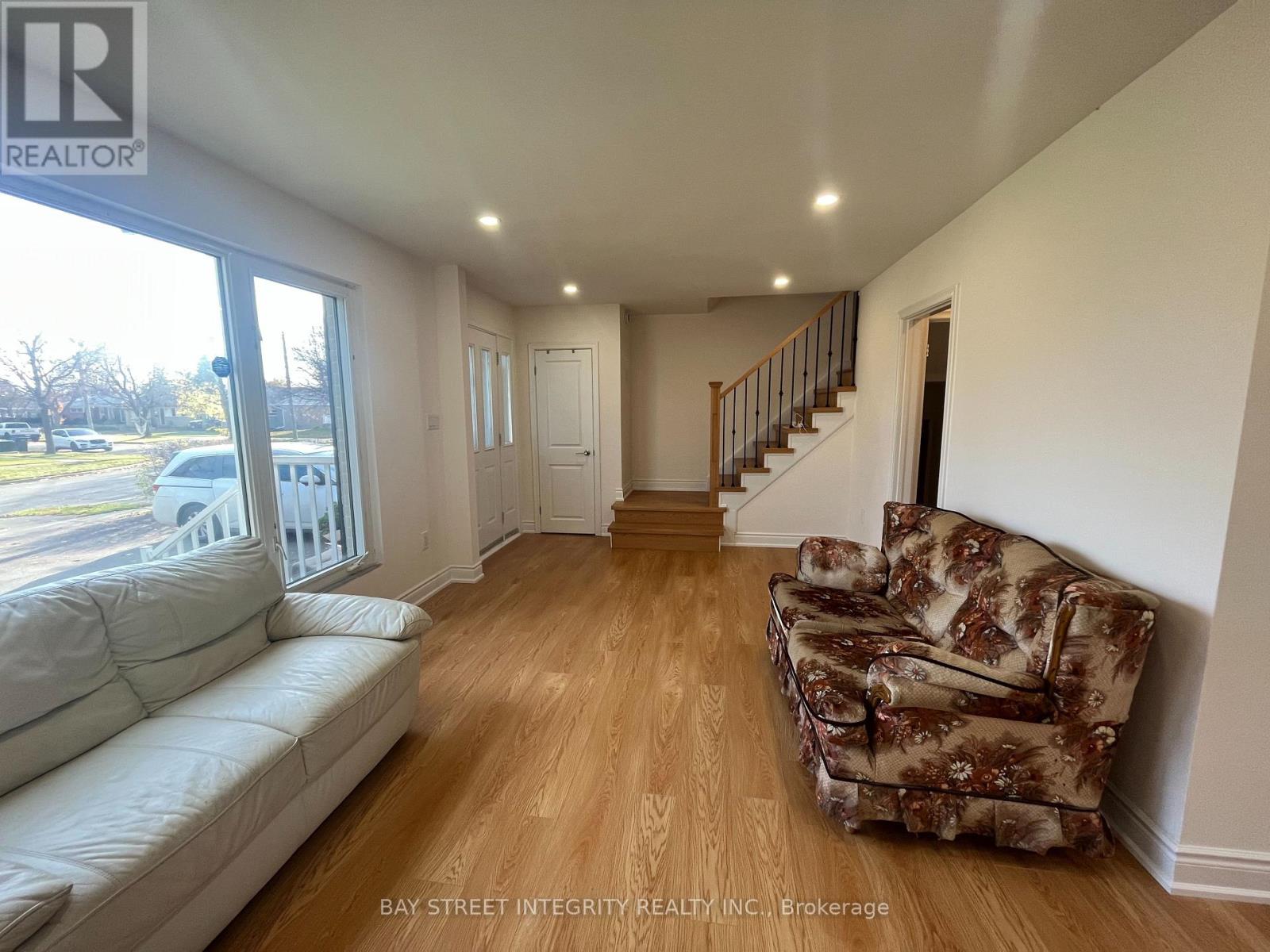 A living room with a couch and a chair.