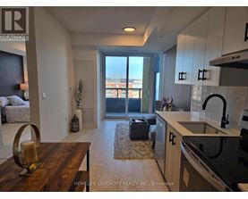 A modern kitchen with a wooden table and a view of the city.