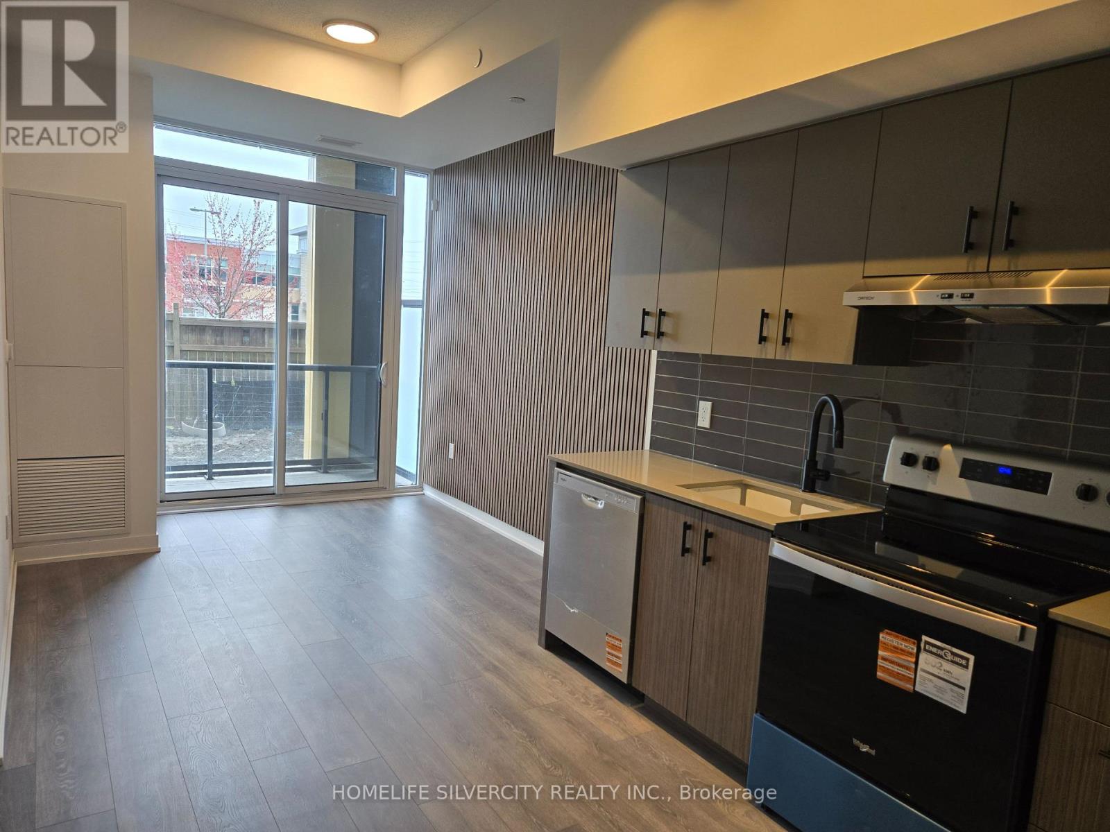 A kitchen with a black dishwasher and a black oven.