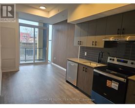 A kitchen with a black dishwasher and a black oven.