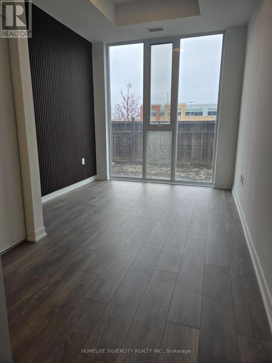 A room with a sliding glass door leading to a backyard.