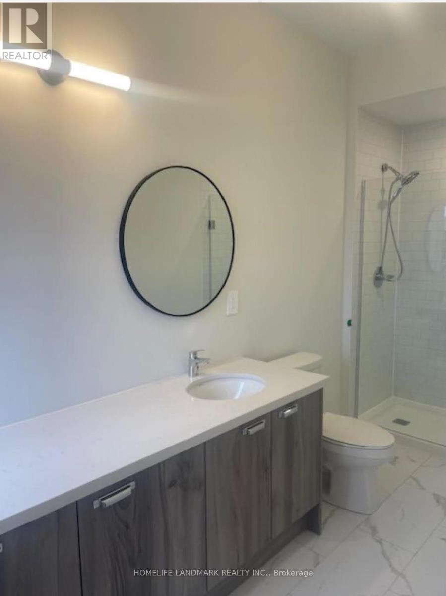 A bathroom with a white counter top and a round mirror.