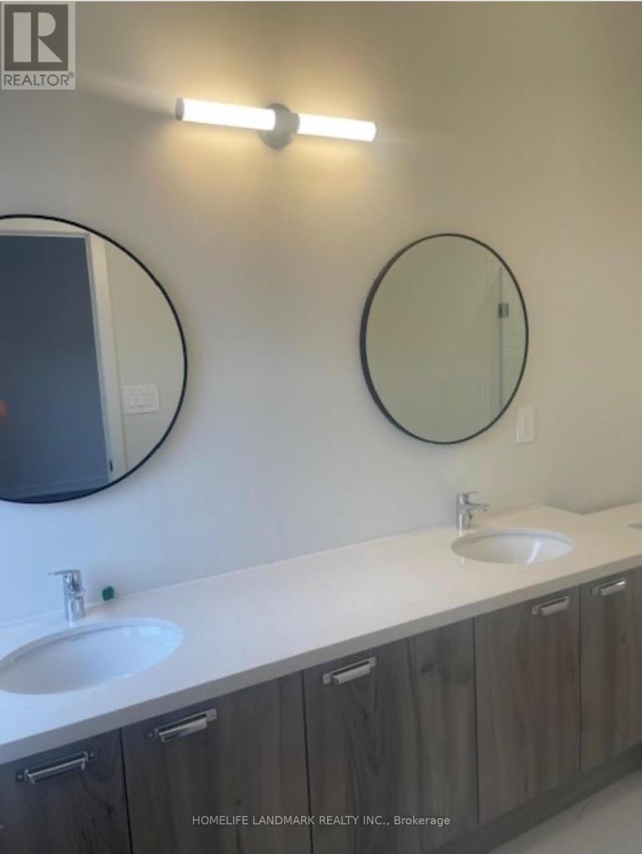 A bathroom with a white counter top and a round mirror.