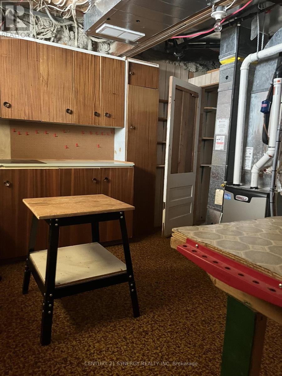 A kitchen area with a table and a stool.
