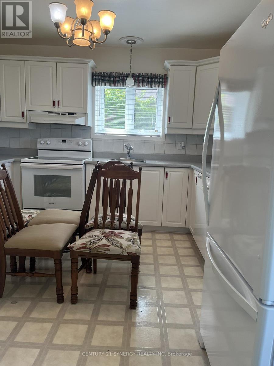 A kitchen with a white refrigerator, a white oven, and a white microwave.