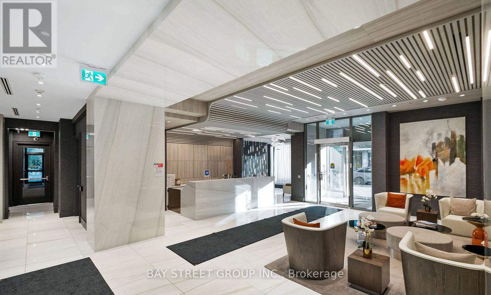A spacious lobby with a reception desk and comfortable seating areas.