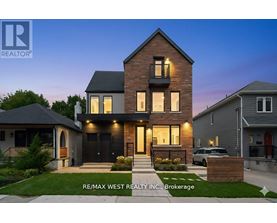 A modern house with a brick facade and a large front yard is for sale through RE/MAX West Realty Inc.