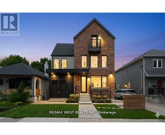 A modern house with a brick facade and a large front yard is for sale through RE/MAX West Realty Inc.