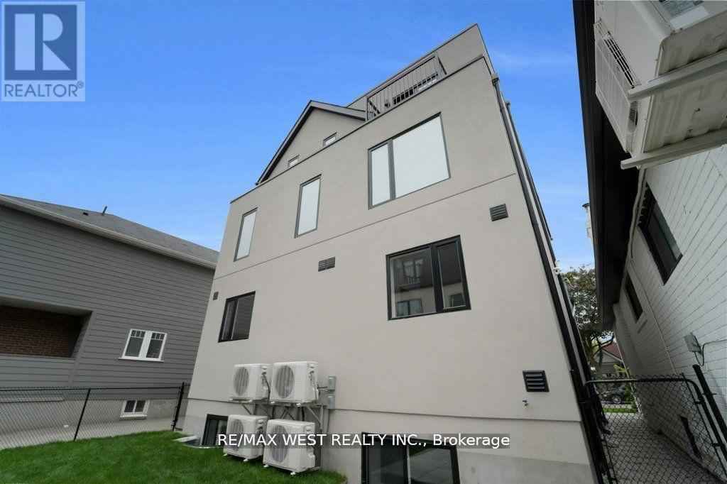 A building with the sign RE/MAX WEST REALTY INC., Brokerage on it.