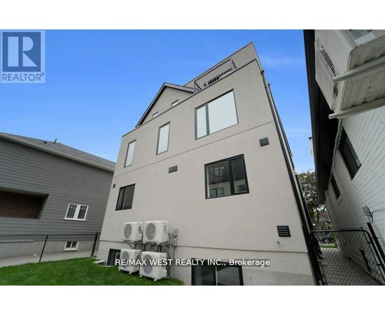 A building with the sign RE/MAX WEST REALTY INC., Brokerage on it.