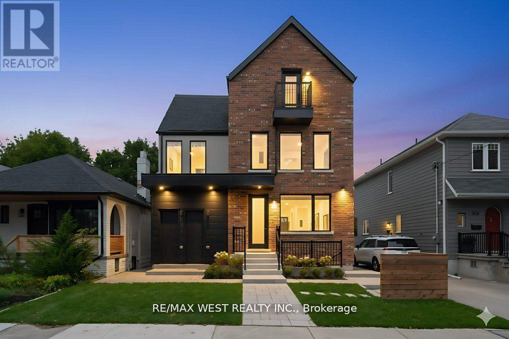 A modern two-story house with a brick facade and a large front porch.
