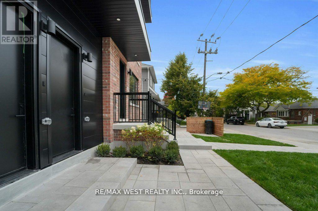 A house with a black door and a sign that says REALTOR.