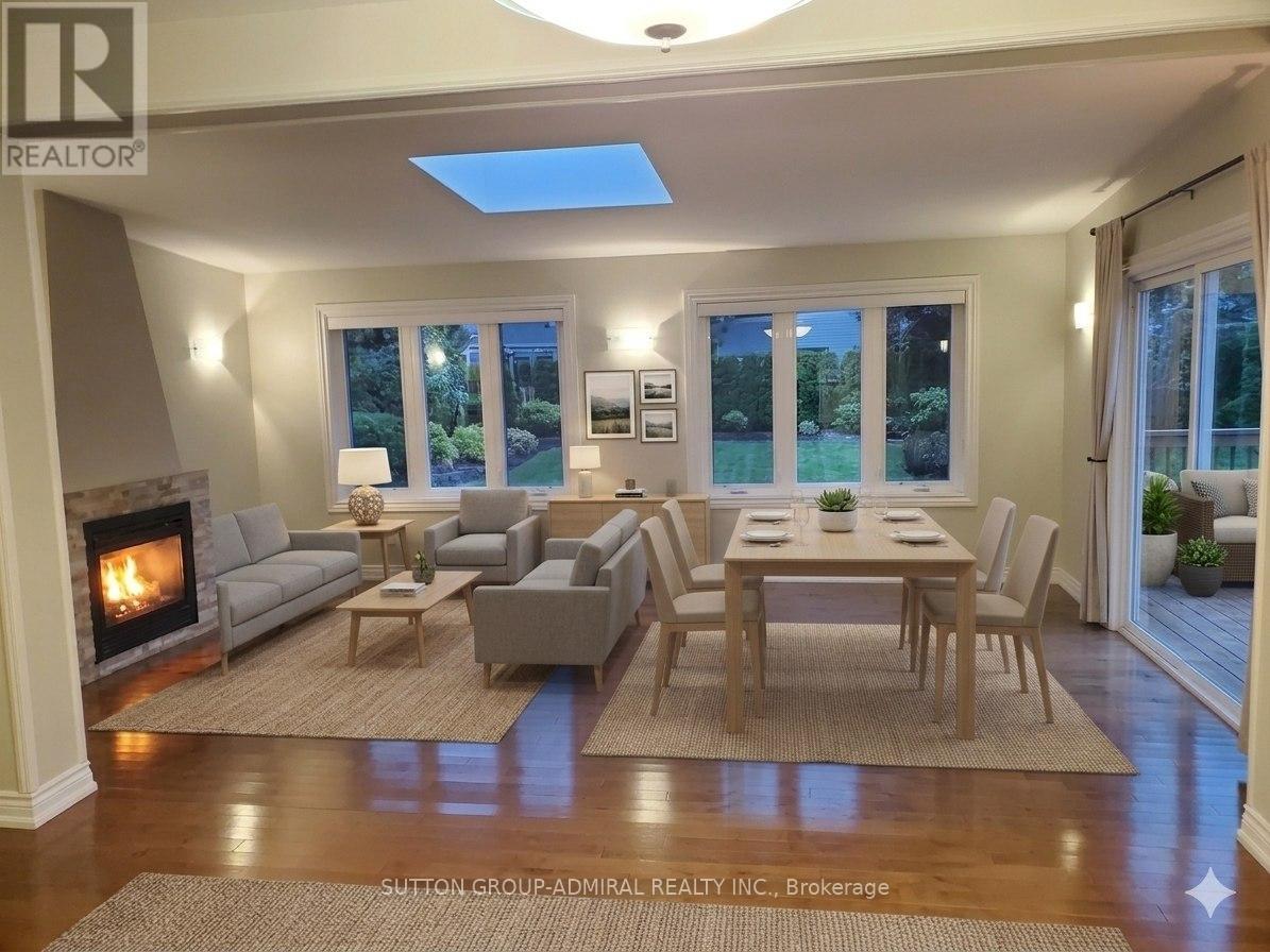 A well-lit living room with a fireplace and a dining table set up.