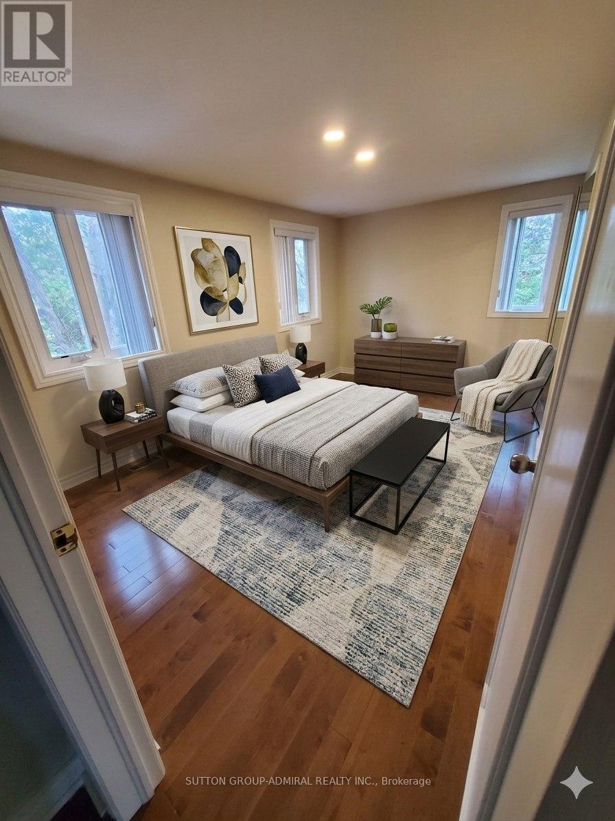 A bedroom with a bed, nightstand, and chair.
