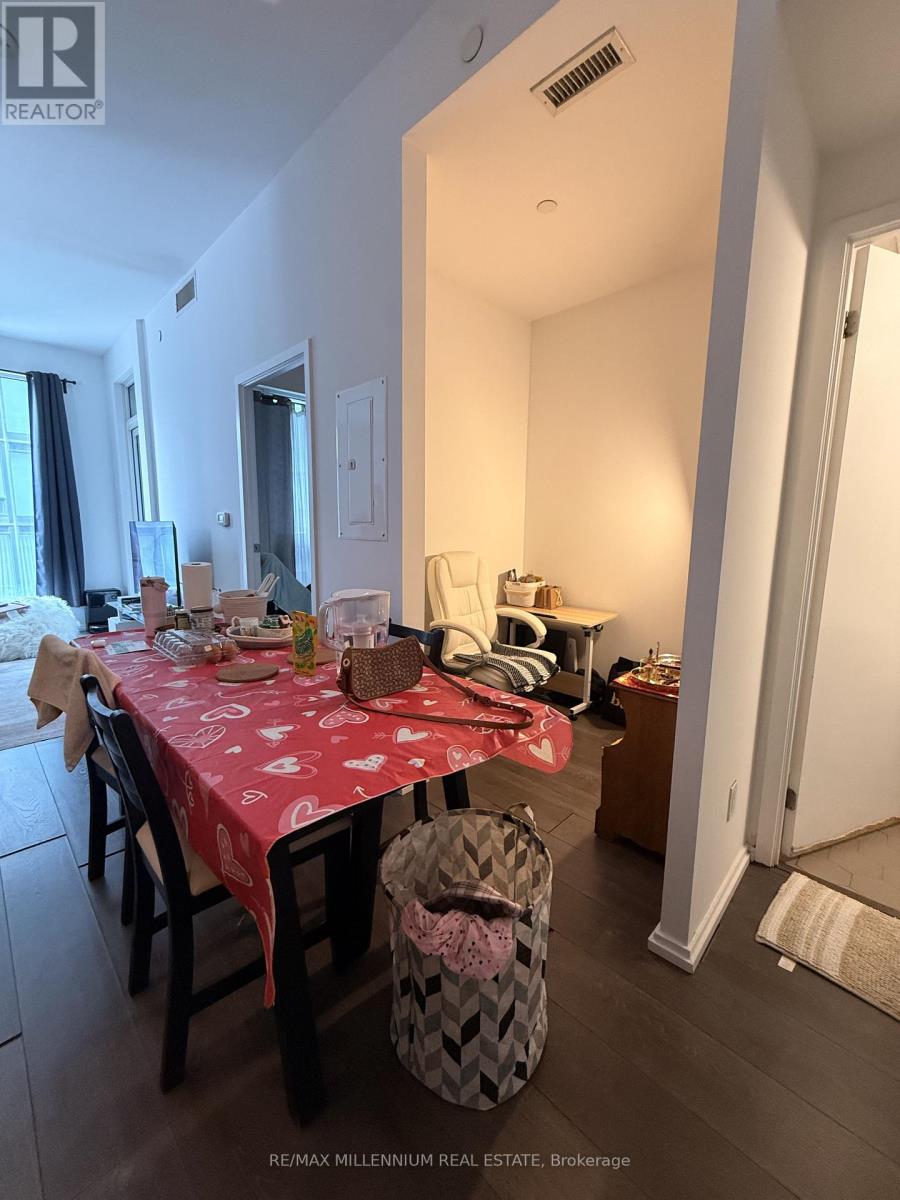A dining room with a table set for a meal.
