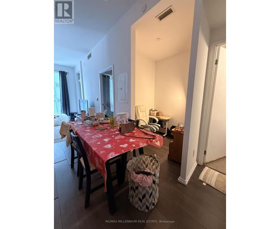A dining room with a table set for a meal.