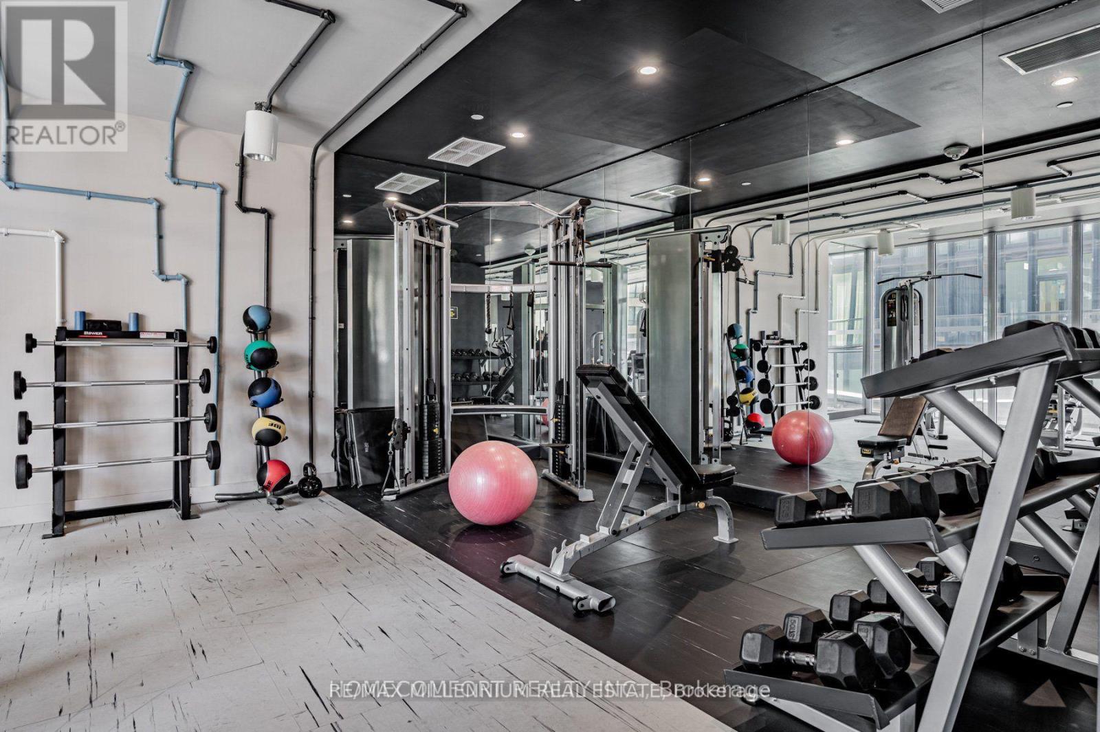 A well-equipped gym with various exercise machines and free weights.