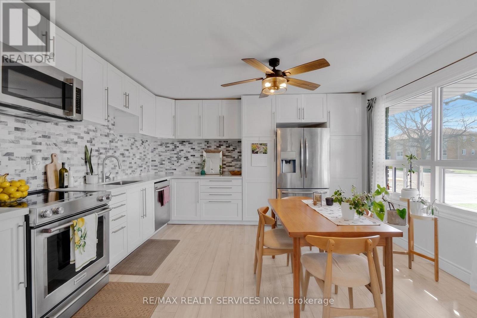 A kitchen with a table and chairs in the middle of the room.