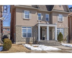 A house with a front yard and a snow-covered ground.