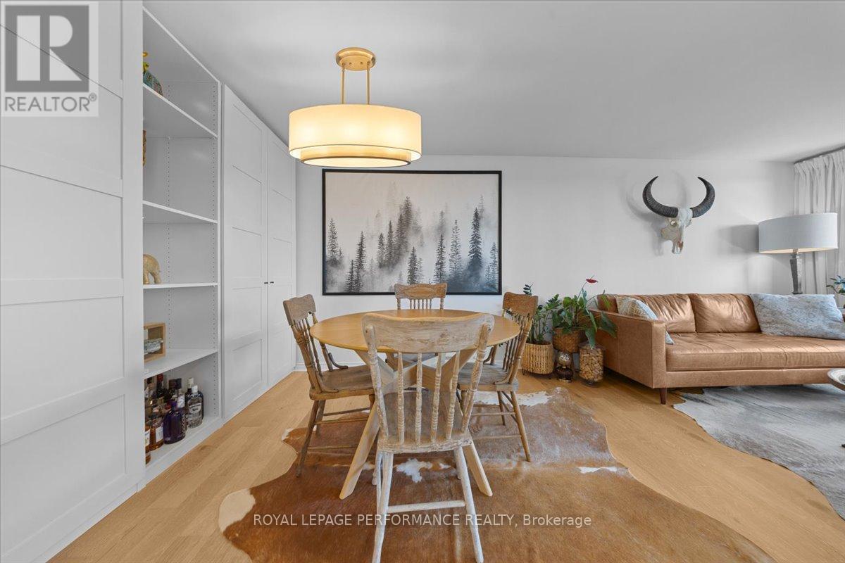 A dining room with a wooden table and chairs.