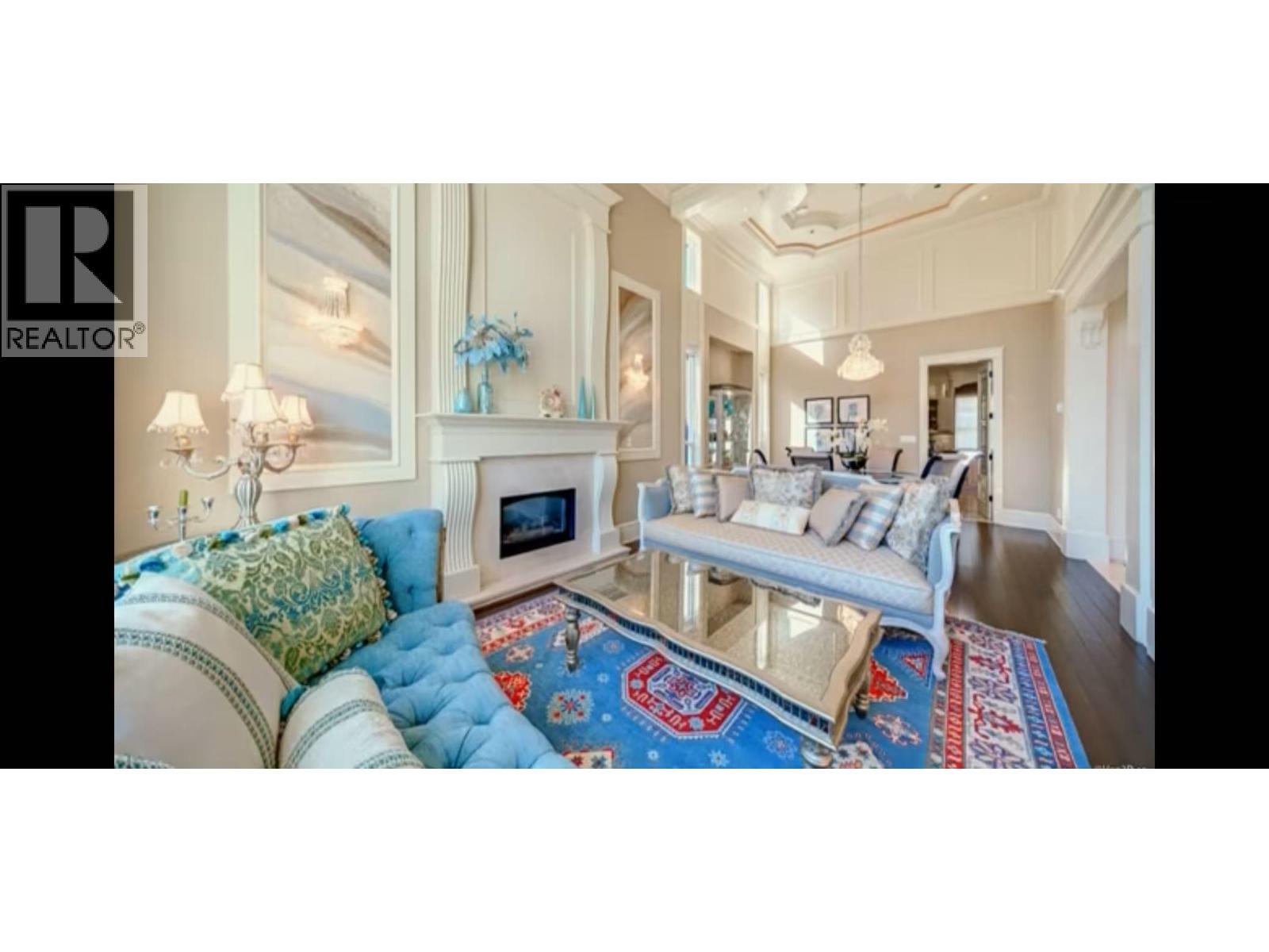 A living room with a blue and red rug on the floor.