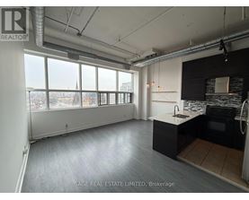 A spacious kitchen and living room with a view of the city.