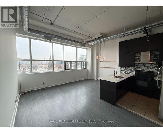 A spacious kitchen and living room with a view of the city.